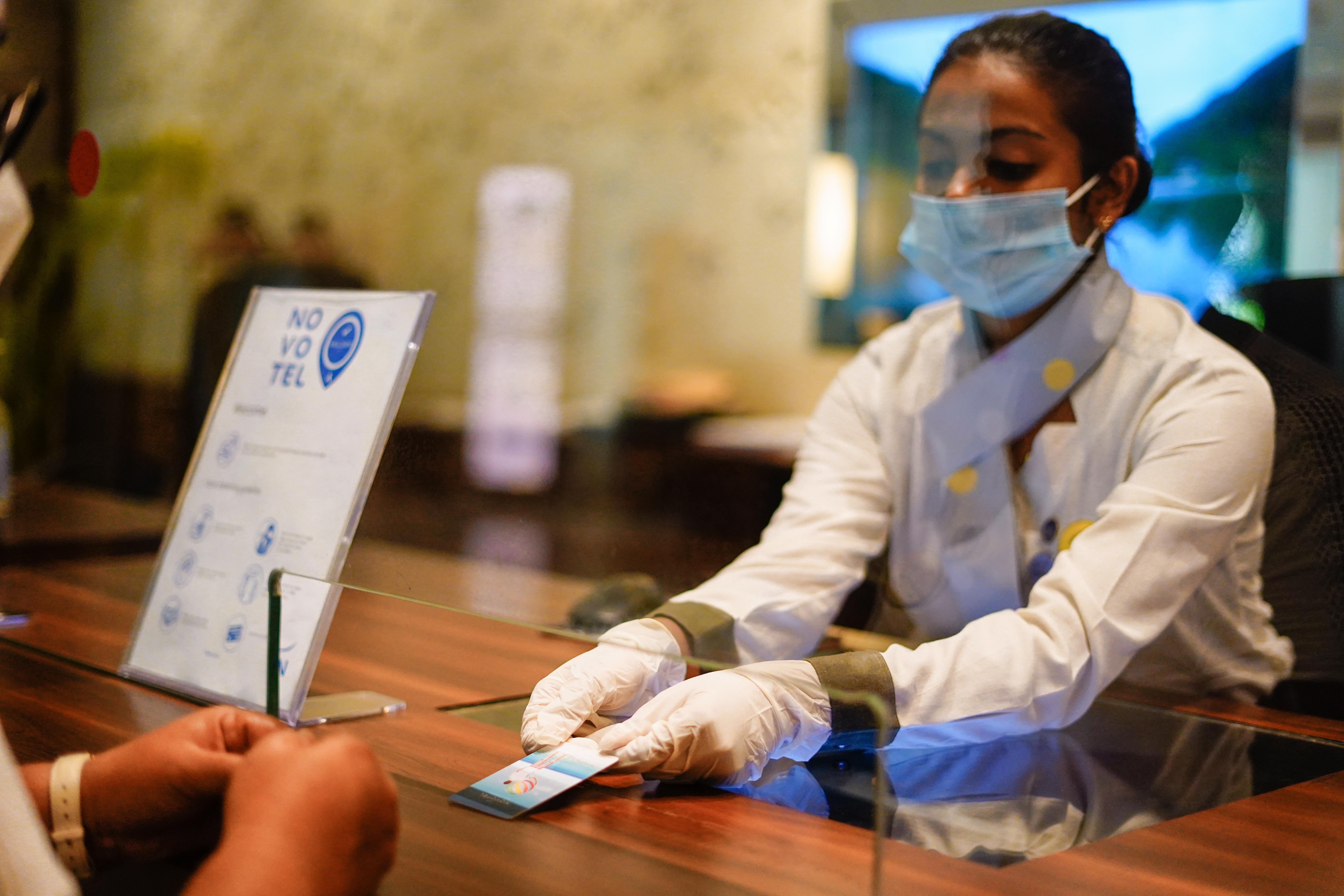 Novotel Goa Resort & Spa Candolim Εξωτερικό φωτογραφία A hotel employee wearing a face mask and gloves